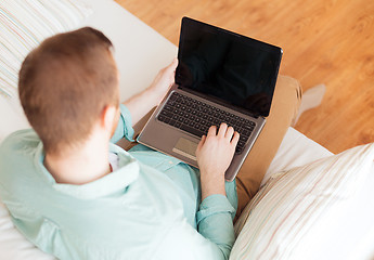 Image showing close up of man working with laptop at home