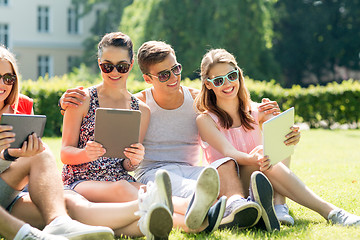 Image showing smiling friends with tablet pc computers in park