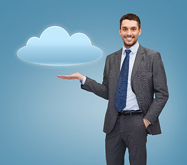 Image showing smiling businessman holding cloud icon