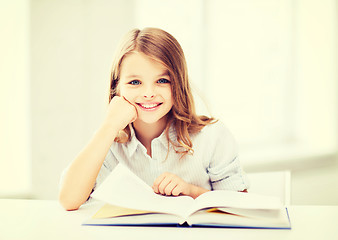 Image showing little student girl studying at school