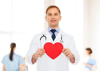 Image showing smiling male doctor with red heart and stethoscope