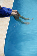 Image showing Attractive man with blue swimsuit enjoys sun