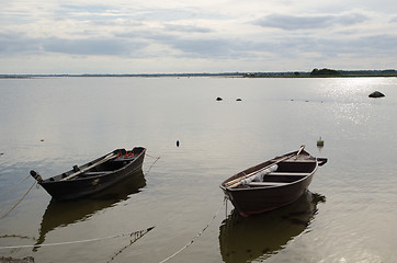 Image showing Two old wooden rowing boats by the coast