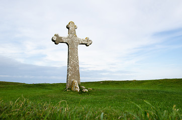 Image showing Ancient cross surrounded of green grass