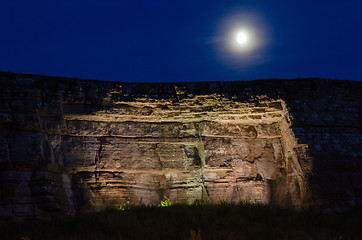 Image showing Moon over illuminated limestone cliff