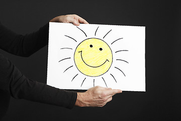 Image showing Man holding billboard with sun