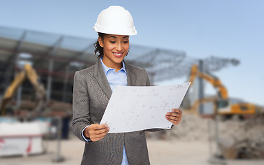 Image showing businesswoman in white helmet with blueprint