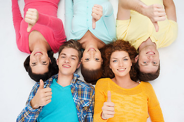 Image showing group of smiling teenagers showing thumbs up