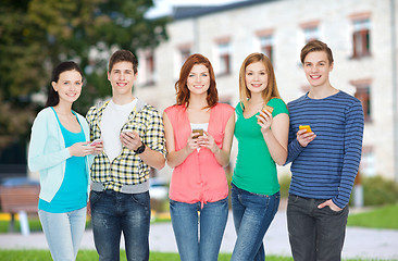 Image showing smiling students with smartphones