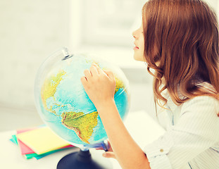 Image showing curious student girl with globe at school