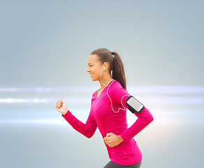 Image showing smiling young woman running