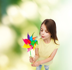 Image showing smiling child with colorful windmill toy