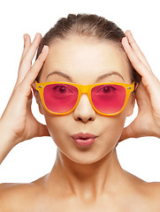 Image showing surprised teenage girl in pink sunglasses