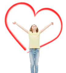 Image showing smiling teenage girl with raised hands