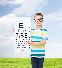 Image showing smiling boy in eyeglasses with white blank board