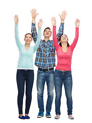 Image showing group of smiling teenagers with raised hands