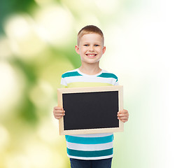 Image showing smiling little boy holding blank black chalkboard