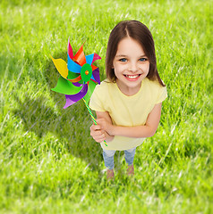 Image showing smiling child with colorful windmill toy