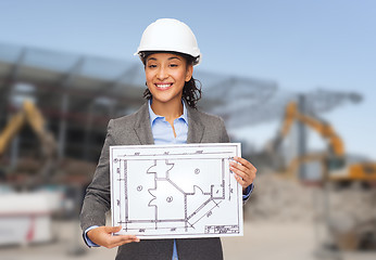 Image showing businesswoman in white helmet with blueprint