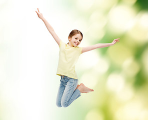 Image showing smiling little girl jumping