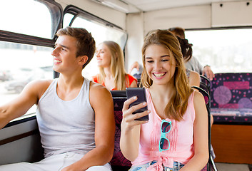 Image showing smiling couple with smartphone making selfie