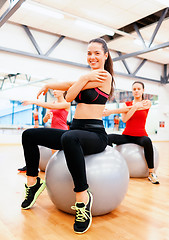 Image showing smiling people exercising in pilates class