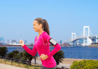 Image showing smiling young woman running outdoors