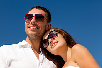 Image showing smiling couple over blue sky background