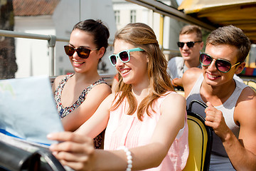 Image showing group of smiling friends traveling by tour bus