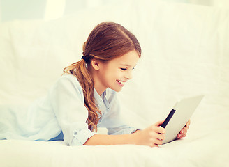 Image showing smiling girl with tablet computer at home