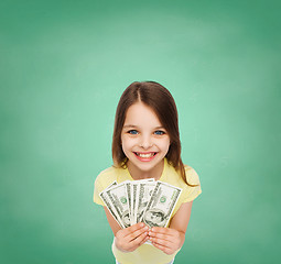 Image showing smiling little girl with dollar cash money