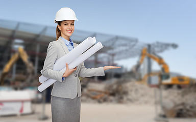 Image showing smiling architect in helmet with blueprint