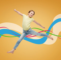 Image showing smiling little girl jumping