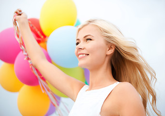 Image showing woman with colorful balloons outside