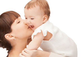 Image showing happy mother kissing baby