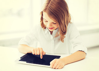 Image showing smiling little girl with tablet pc at school