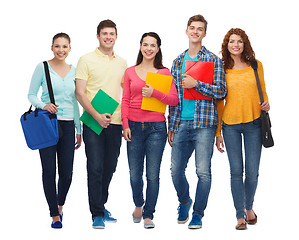 Image showing group of smiling teenagers with folders and bags