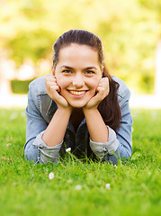 Image showing smiling young girl lying on grass