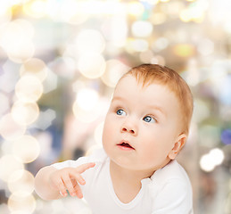 Image showing curious baby looking side