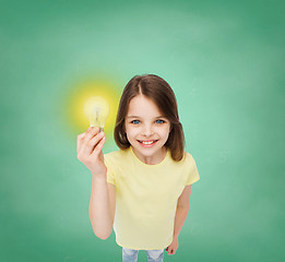 Image showing smiling little girl holding light bulb