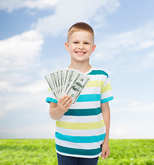 Image showing smiling boy holding dollar cash money in his hand