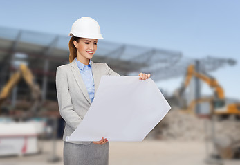 Image showing businesswoman in white helmet with blueprint