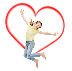 Image showing smiling little girl jumping