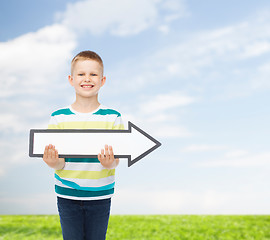 Image showing smiling little boy with blank arrow pointing right