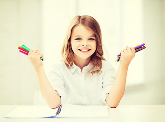 Image showing smiling girl showing colorful felt-tip pens