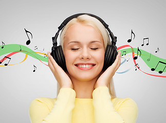 Image showing smiling young woman with headphones