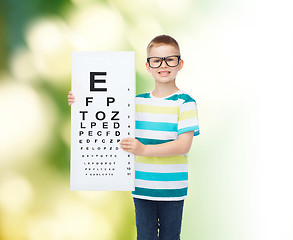 Image showing smiling boy in eyeglasses with white blank board