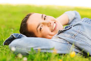 Image showing smiling young girl lying on grass