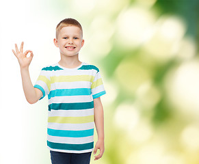 Image showing little boy in casual clothes making OK gesture