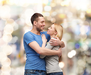 Image showing smiling couple hugging and looking at each other